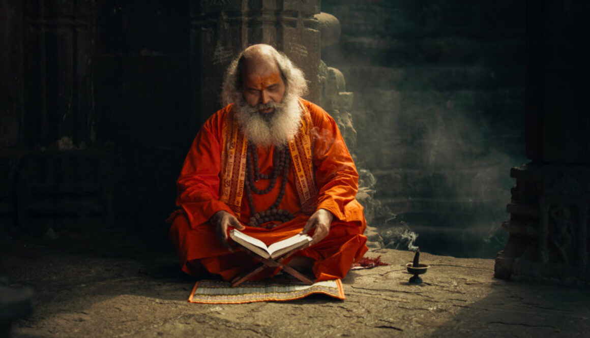 Portrait of Old Indian Monk Reading a Book in an Ancient Temple. Senior Guru Getting Wisdom from Sacred Texts, Humble Male Devoted to Hinduism, Gaining Knowledge and Spiritual Connection